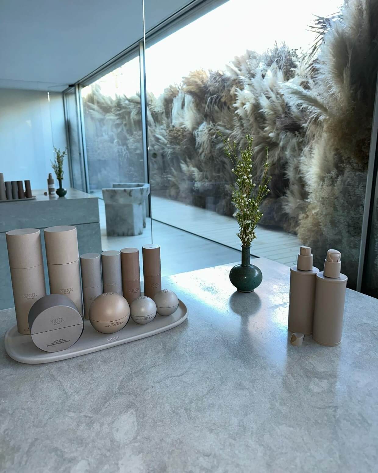 Kim's living areas include neutral tones and floor-to-ceiling windows for natural lighting